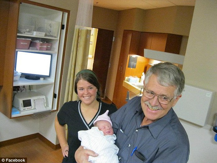 Kayla, with her father Carl Mueller, celebrating the birth of a baby in the family at home in Arizona in 2011