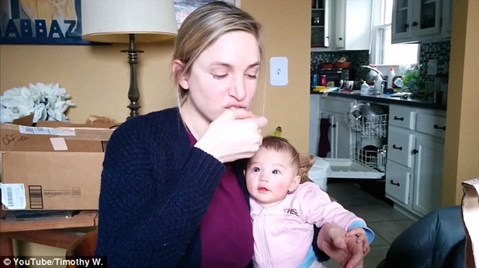 The baby girl is mesmerised by the loud and sudden noises that the crisps make