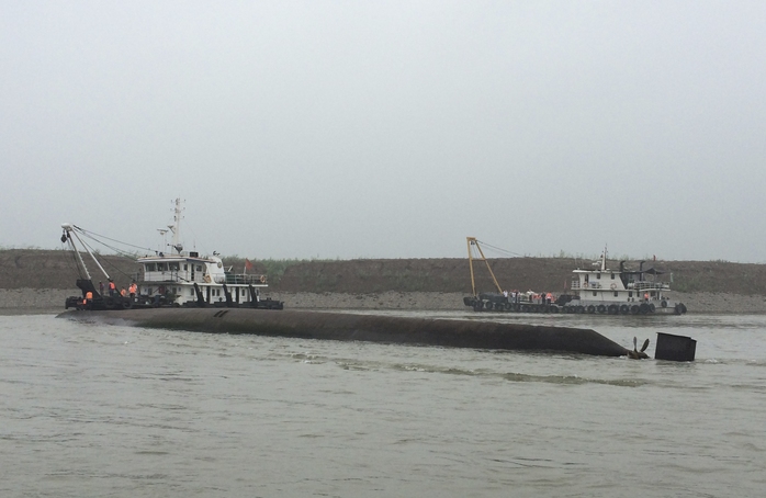 Rescue workers arrive near the capsized ship, center, on the Yangtze River in central Chinas Hubei province Tuesday, June 2, 2015.  The small...