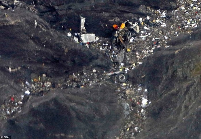 Crash site: Pieces of debris, including what appear to be parts of the aircrafts tail fin and a wheel, are seen strewn on the mountainside