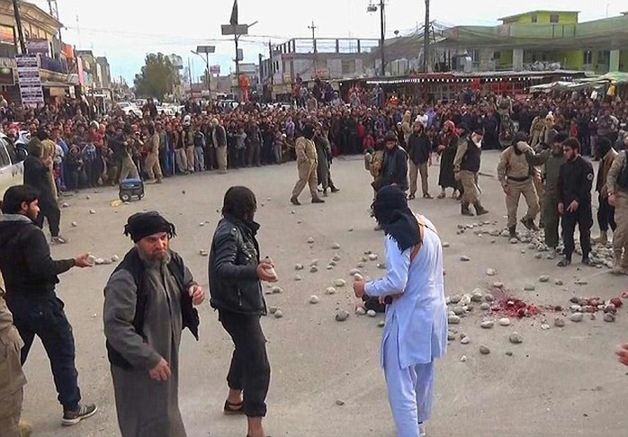 Barbaric: The Islamic State militants begin throwing stones at the defenceless and blindfolded couple, who have had their hands bound to prevent them getting away