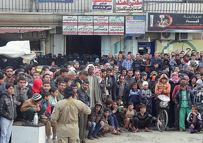 Bloodthirsty: With heavily armed militants taking up positions on ledges overlooking the crowd, the young men and boys jostle to ensure they get the best view of the murder