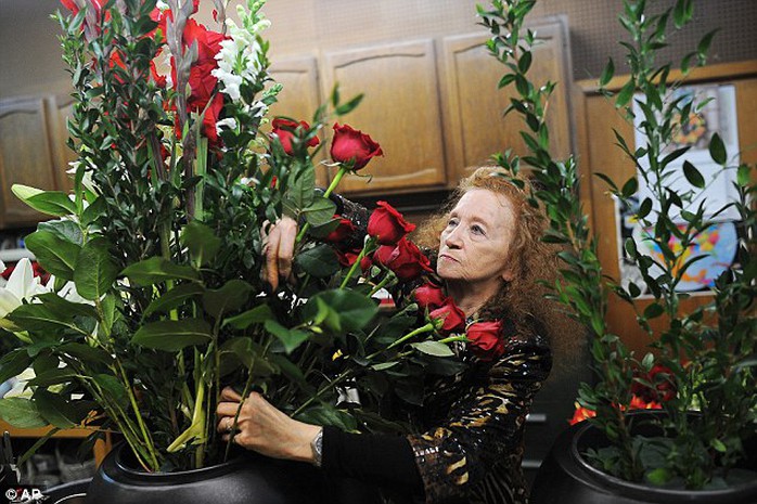 Marie Majusiak, owner of Watertown Flowers, works on a one of two flower arrangements  ahead of President Barack Obamas visit