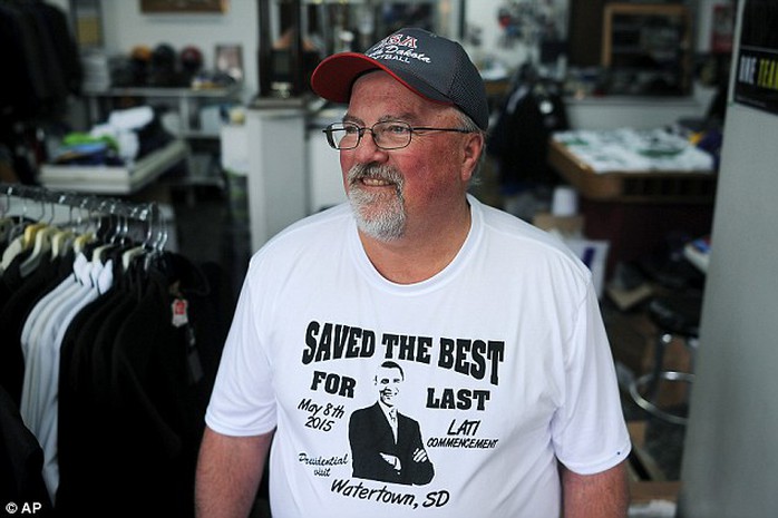 Gary Young, owner of Youngs Primtime Sports, in Watertown, S.D., poses for a portrait in a Saved the Best for Last t-shirt he made for the visit