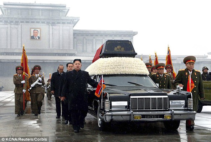 Chilling: Kim Jong-un (centre) marches at the head of the hearse carrying his father Kim Jong-ils coffin in Pyongyang on December 29, 2011