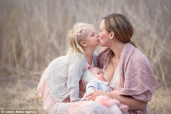 Beautiful: A mother breastfeeds her baby in a wheat field in a photo taken by Tammy Nicole