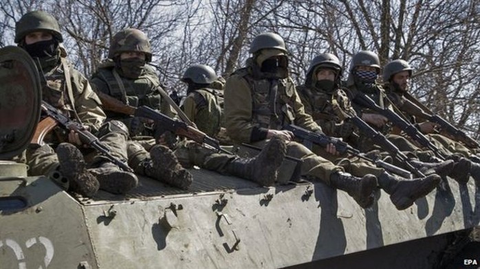 Pro-Russian rebels drive on an armoured military vehicle near city of Donetsk, Ukraine