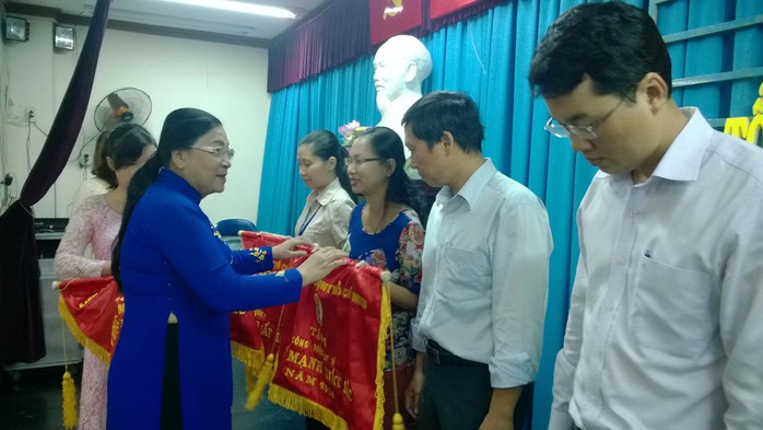 Bà Nguyễn Thị Bích Thủy, Phó Chủ tịch LĐLĐ TP HCM, trao cờ thi đua cho các đơn vị xuất sắc tại quận Tân Phú, TP HCM Ảnh: CAO HƯỜNG