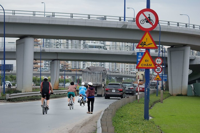 Không chỉ xe máy mà nhiều phương tiện xe đạp và đi bộ cũng lưu thông trên cầu vượt, bất chấp nguy hiểm