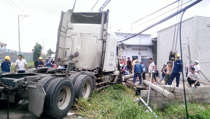 Chiếc xe container mất lái tông gãy trụ điện và ủi sập tường nhà dân, vào rạng sáng 21-7