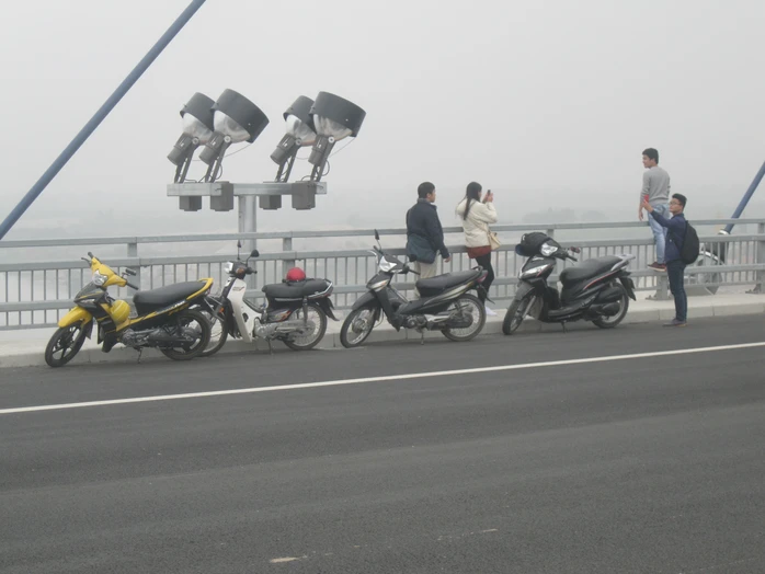 Người tham gia giao thông dừng, đỗ xe và chụp ảnh trên cầu Nhật Tân