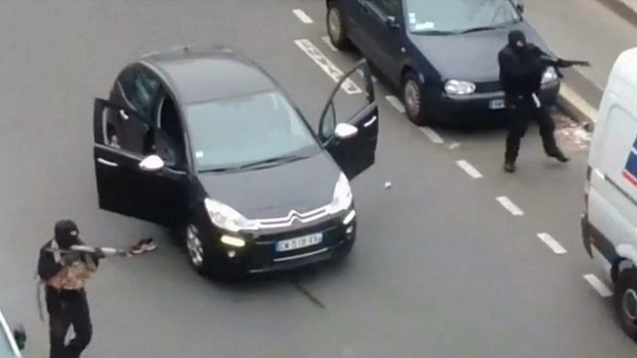 Two gunmen outside the offices of French satirical newspaper Charlie Hebdo in Paris.