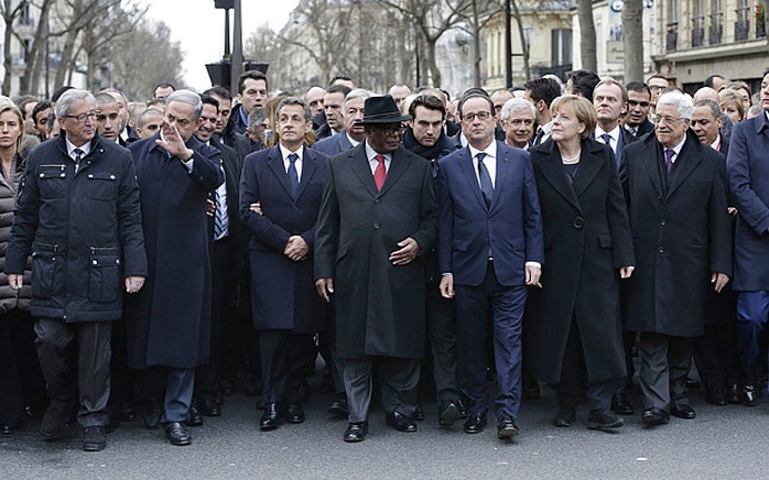 French President Francois Hollande is surrounded by head of states as they attend a solidarity march  in the streets of Paris
