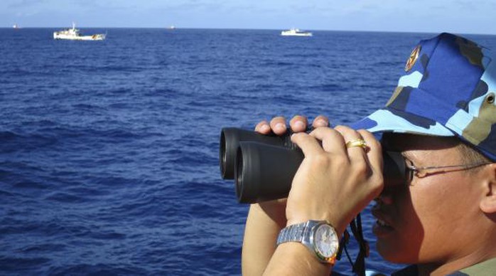 A crewman from the Vietnamese coastguard ship 8003 looks out at sea as Chinese coastguard vessels give chase to Vietnamese ships that came close to the Haiyang Shiyou 981, known in Vietnam as HD-981, oil rig in the South China Sea in this July 15, 2014 file photo. REUTERS/Martin Petty/Files