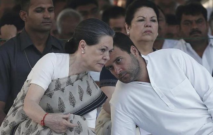 Congress party chief Sonia Gandhi (L) listens to her son and lawmaker Rahul Gandhi (R), at her husband and former Indian Prime Minister Rajiv Gandhis memorial, on the occasion of his 23rd death anniversary, in New Delhi May 21, 2014.  REUTERS/Adnan Abidi/Files