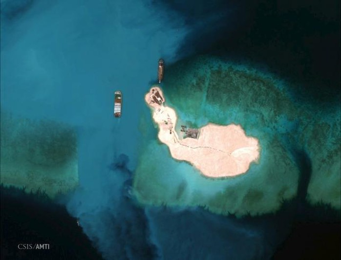 At the southernmost feature, cargo is unloaded onto the shore of Mischief Reef, located 216 km (135 miles) west of the Philippine island of Palawan, in this Center for Strategic and International Studies (CSIS) Asia Maritime Transparency Initiative satellite image taken on March 16, 2015 and released to Reuters on April 9, 2015.    REUTERS/CSISs Asia Maritime Transparency Initiative/Digital Globe/Handout