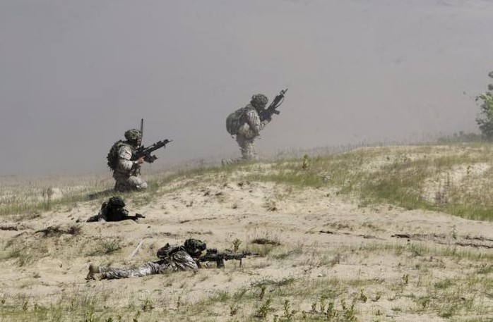 Latvias army soldiers take their positions during the multinational NATO exercise Saber Strike in Adazi, Latvia, June 11, 2015. REUTERS/Ints Kalnins