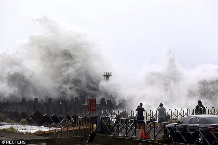 In the  northeastern coastal town of Nanfangao in Ilan county, northern Taiwan, people take pictures of waves