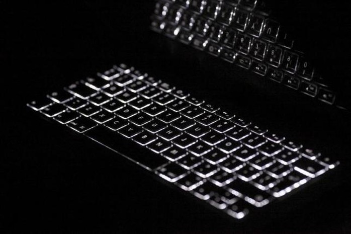 Backlit keyboard is reflected in screen of Apple Macbook Pro notebook computer in Warsaw February 6, 2012.  REUTERS/Kacper Pempel