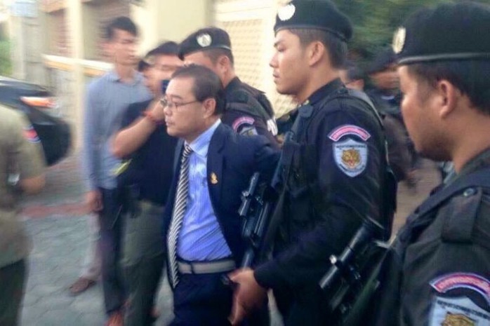 Opposition senator Hong Sok Hour is escorted into a police SUV outside a private residence in Phnom Penhs Sen Sok district, in a photograph posted the Facebook page of opposition leader Sam Rainsy.