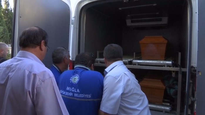 Three coffins were loaded into a van apparently bound for a local airport.