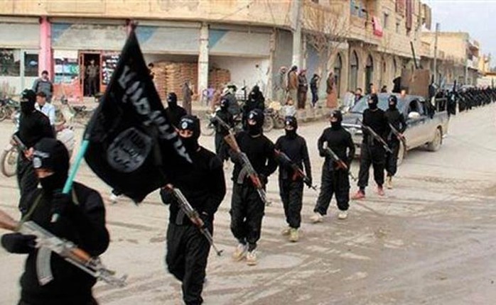 Một nhóm binh sĩ IS mang cờ của tổ chức này. Họ cũng có thể bị chính IS xử tử nếu đào ngũ hoặc thua trận. Ảnh: AP