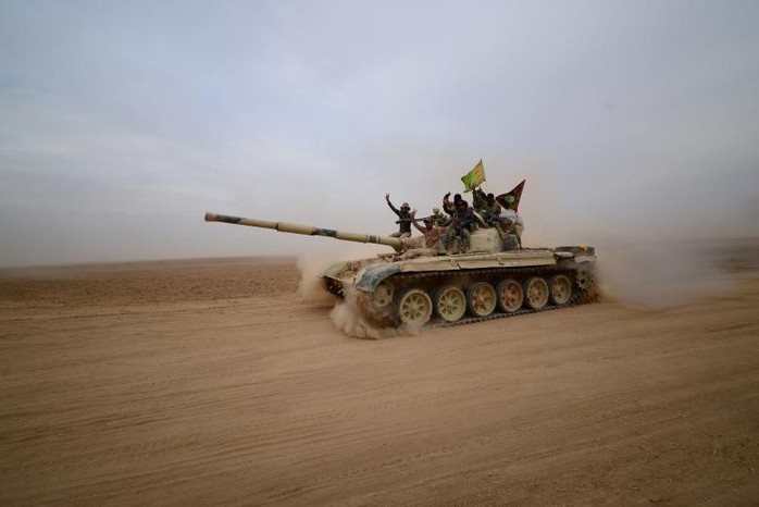 Chiến binh người Shiite lái xe tăng về phía Tal Afa, phía Tây Mosul hôm 16-11. Ảnh: REUTERS