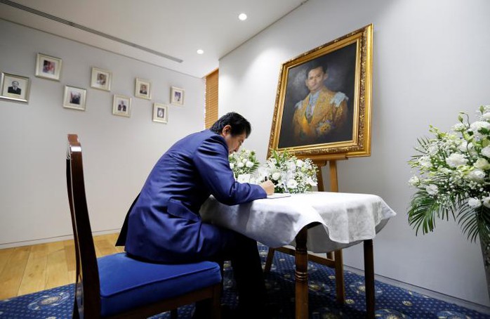 Thủ tướng Nhật Bản Shinzo Abe viết vào sổ chia buồn tại đại sứ quán Thái Lan ở Tokyo. Ảnh: Reuters