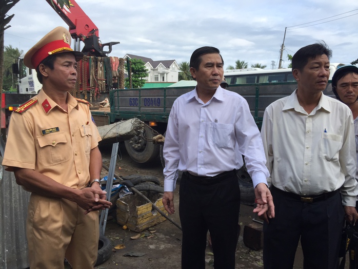 
Thượng tá Trần Bình (trái), Phó phòng CSGT, báo cáo sơ bộ vụ tai nạn với ông Lê Văn Hưởng (giữa)

