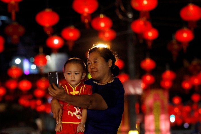 Hai bà cháu tự sướng trên phố đèn lồng ở TP Yangon – Myanmar. Ảnh: REUTERS