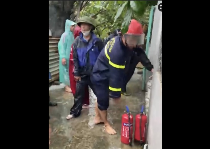 Cảnh sát cùng người dân múc nước lụt để chữa cháy nhà - Ảnh 1.