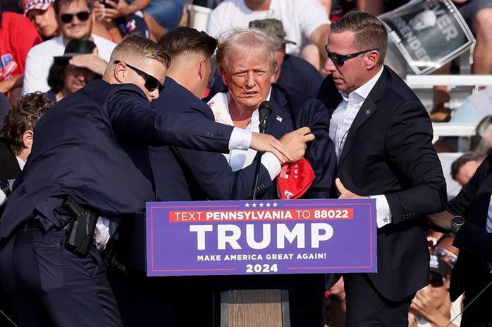 Mật vụ Mỹ chạy lên sâu khấu ngay khi cựu Tổng thống Donald Trump trúng đạn tại sự kiện vận động tranh cử hôm 13-7 ở TP Butler. Ảnh: Reuters Mật vụ Mỹ chạy lên sâu khấu ngay khi cựu Tổng thống Donald Trump trúng đạn tại sự kiện vận động tranh cử hôm 13-7 ở TP Butler. Ảnh: Reuters