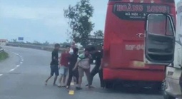 Xe khách và xe container dừng lại giữa đường, người trên xe lao vào đánh nhau
