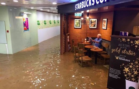 Hồng Kông phát cuồng vì cụ ông ngồi quán cafe giữa nước lụt