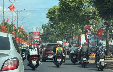 Từng đoàn người cưỡi xe máy về quê đón Tết trên Quốc lộ 14