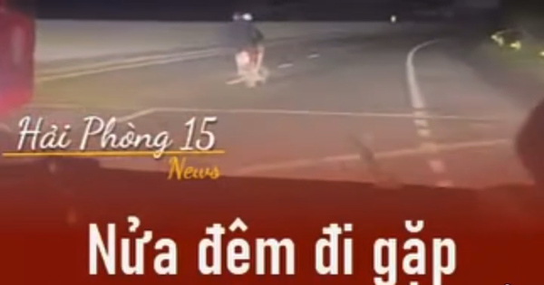 Hai người đàn ông đầu trần, đi xe máy lạng lách, đánh võng trên quốc lộ